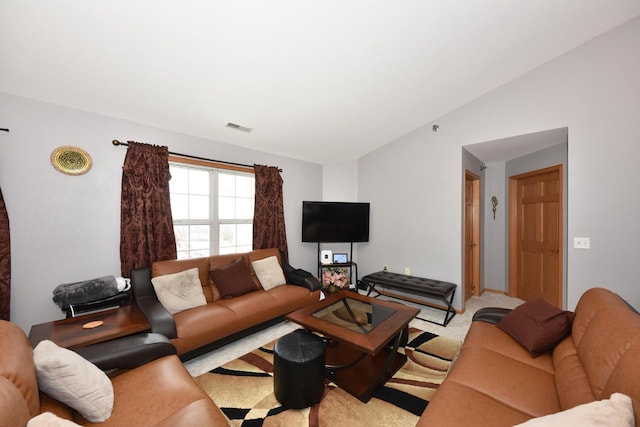living area featuring visible vents, carpet, and lofted ceiling