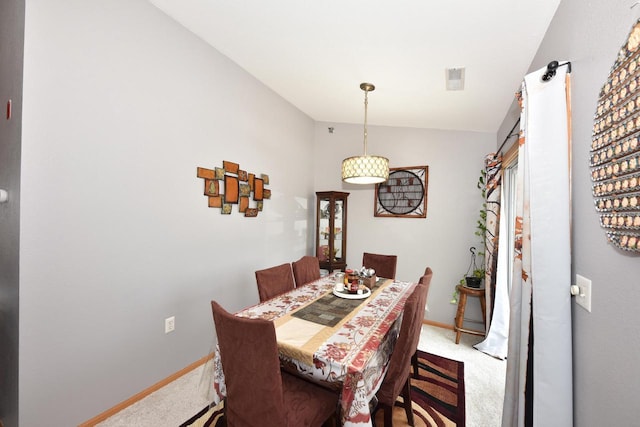 dining area with baseboards, carpet, and vaulted ceiling