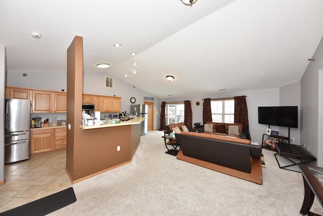 living room with visible vents, light colored carpet, and vaulted ceiling