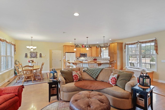 9521 County Road Ww, Wisconsin Rapids, WI 54494 - living room with light wood-type flooring, baseboards, recessed lighting, and an inviting chandelier