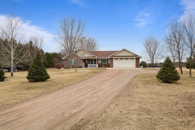 9521 County Road Ww, Wisconsin Rapids, WI 54494 - ranch-style home with brick siding, dirt driveway, an attached garage, and a front lawn
