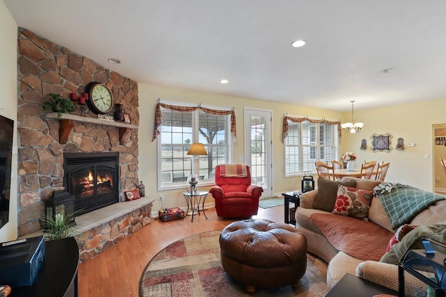 9521 County Road Ww, Wisconsin Rapids, WI 54494 - living area featuring a healthy amount of sunlight, a chandelier, wood finished floors, and a fireplace