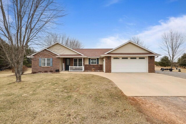 9521 County Road Ww, Wisconsin Rapids, WI 54494 - single story home featuring concrete driveway, a front lawn, a porch, brick siding, and a garage
