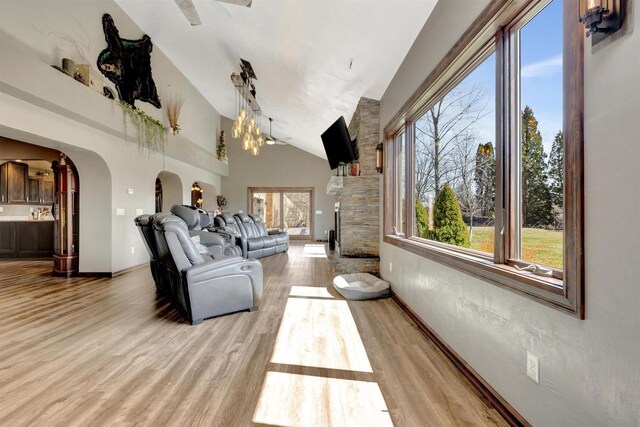 1545 County Rd I, Oshkosh, WI 54902 - living room with arched walkways, light wood-style floors, high vaulted ceiling, and a wealth of natural light