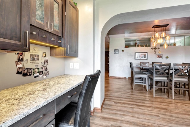 1545 County Rd I, Oshkosh, WI 54902 - dining space featuring light wood-style flooring, arched walkways, and baseboards