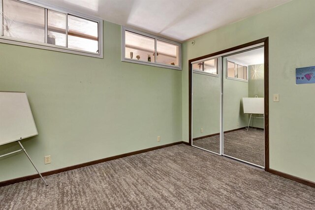 1545 County Rd I, Oshkosh, WI 54902 - unfurnished bedroom featuring carpet, multiple windows, and baseboards