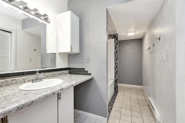 1545 County Rd I, Oshkosh, WI 54902 - full bath featuring tile patterned floors, shower / tub combination, vanity, and baseboard heating