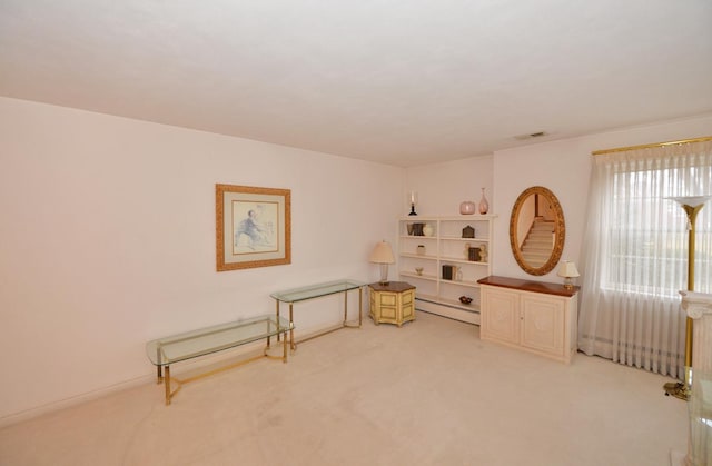 living area featuring carpet flooring, visible vents, and a baseboard radiator