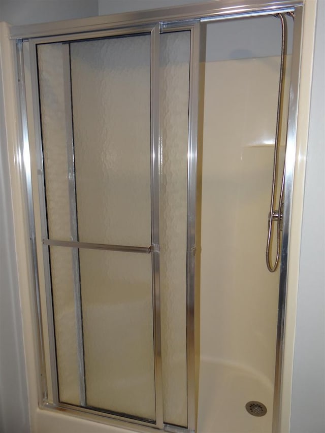 full bath with a shower stall