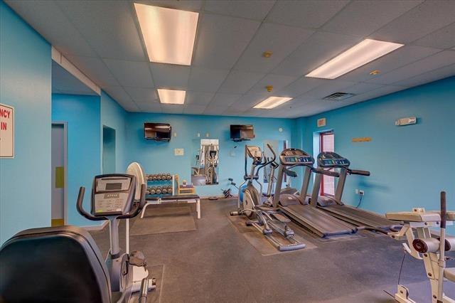exercise room featuring visible vents and a paneled ceiling