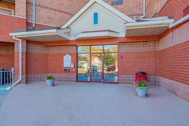 exterior space with a patio and brick siding