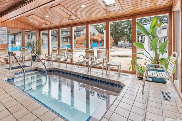 view of swimming pool featuring a patio area and an indoor hot tub