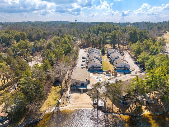 birds eye view of property featuring a view of trees