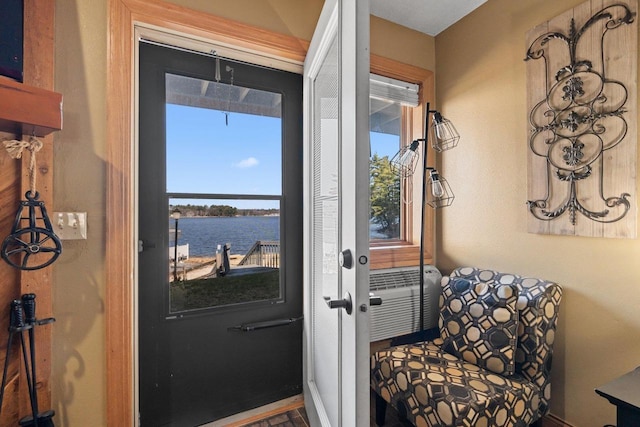 doorway to outside featuring a water view