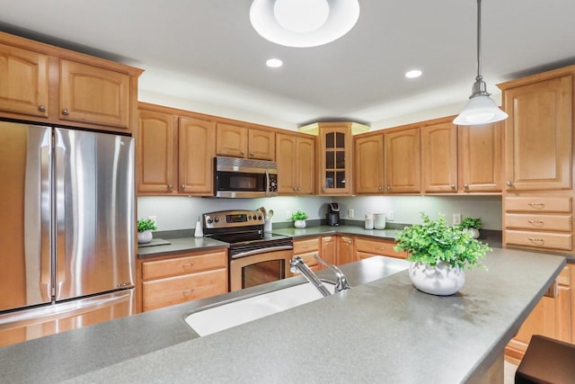123 W Washington Ave Unit 306, Madison, WI 53703 - kitchen featuring stainless steel appliances, glass insert cabinets, decorative light fixtures, recessed lighting, and a sink