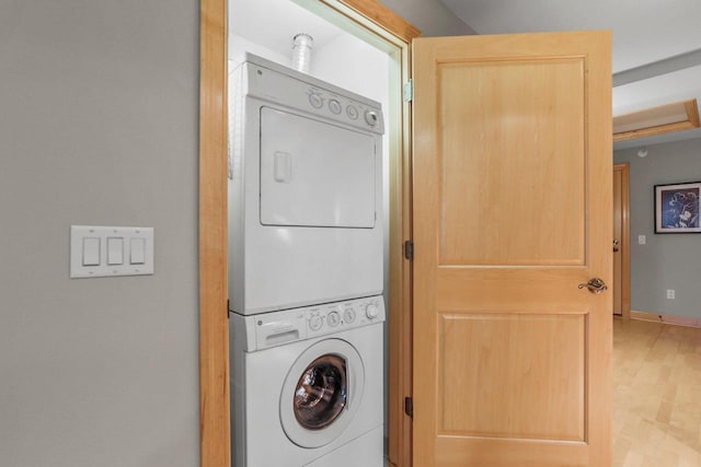 123 W Washington Ave Unit 306, Madison, WI 53703 - washroom featuring stacked washer / dryer and wood finished floors
