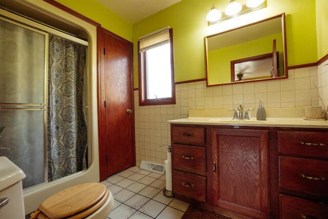 1001 Wisconsin Ave, North Fond Du Lac, WI 54937 - full bath with vanity, tile patterned flooring, toilet, wainscoting, and tile walls