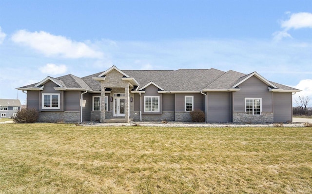 1495 Cattail Ln, Fond Du Lac, WI 54937 - view of front of home with a front lawn, a shingled roof, and stone siding