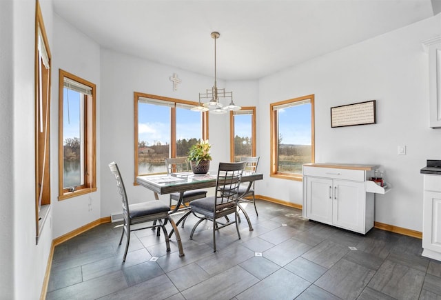 1495 Cattail Ln, Fond Du Lac, WI 54937 - dining room with baseboards and an inviting chandelier