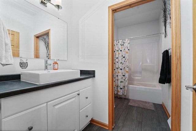 1495 Cattail Ln, Fond Du Lac, WI 54937 - full bath with baseboards, shower / bath combo with shower curtain, vanity, and wood finished floors