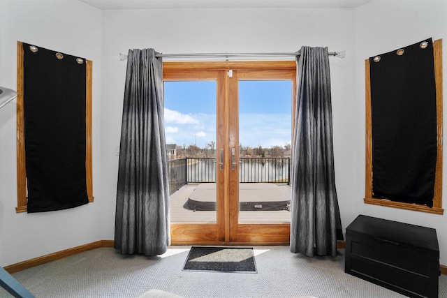 1495 Cattail Ln, Fond Du Lac, WI 54937 - doorway to outside featuring a water view, carpet, and baseboards