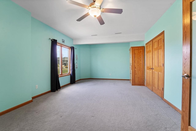 1495 Cattail Ln, Fond Du Lac, WI 54937 - unfurnished room with light carpet, baseboards, and a ceiling fan