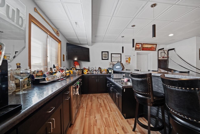 1495 Cattail Ln, Fond Du Lac, WI 54937 - kitchen featuring dark countertops, light wood-type flooring, a kitchen breakfast bar, recessed lighting, and an ornate ceiling