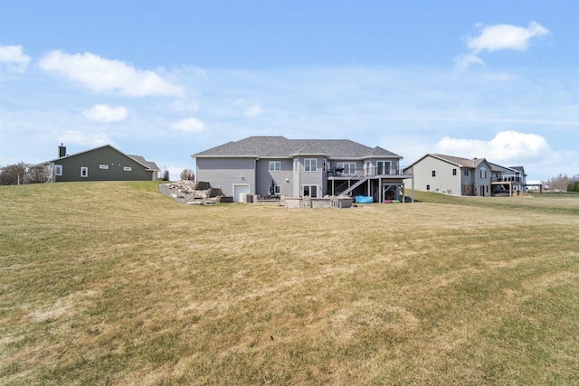 1495 Cattail Ln, Fond Du Lac, WI 54937 - back of property featuring a deck, stairway, and a lawn