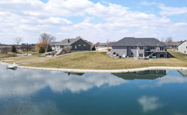 1495 Cattail Ln, Fond Du Lac, WI 54937 - back of property with a water view, stairway, and a lawn