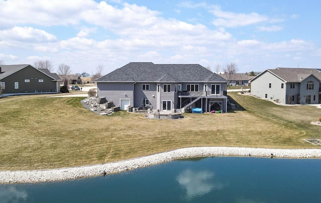 1495 Cattail Ln, Fond Du Lac, WI 54937 - back of house with a residential view, roof with shingles, stairs, a deck with water view, and a yard