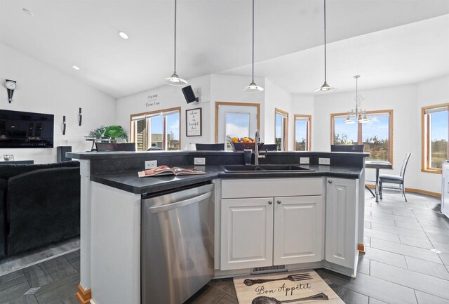 1495 Cattail Ln, Fond Du Lac, WI 54937 - kitchen featuring stainless steel dishwasher, white cabinets, a sink, dark countertops, and open floor plan