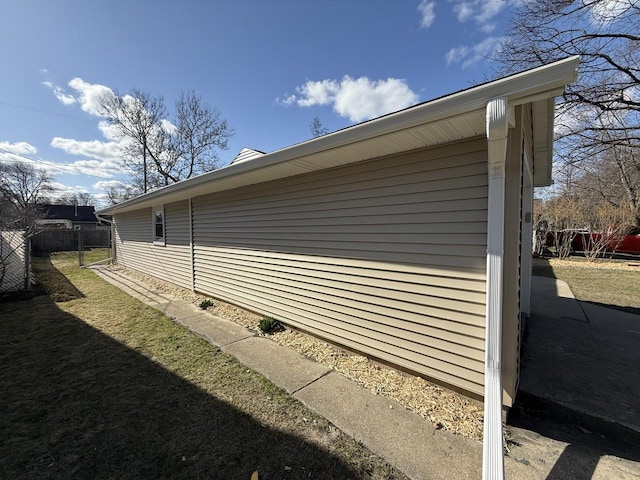 view of side of home featuring fence