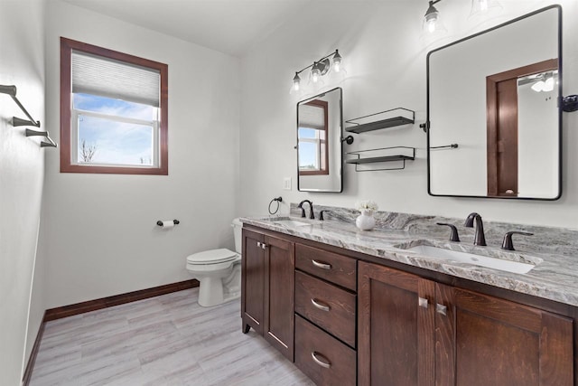 5096 N Milkweed Trl, Appleton, WI 54913 - full bath featuring a sink, baseboards, double vanity, and toilet
