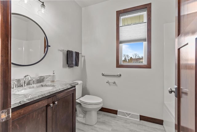 5096 N Milkweed Trl, Appleton, WI 54913 - bathroom with vanity, visible vents, toilet, wood finished floors, and baseboards