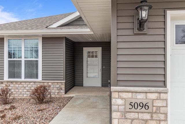5096 N Milkweed Trl, Appleton, WI 54913 - doorway to property with roof with shingles, stone siding, and covered porch