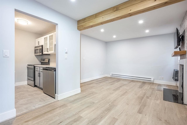 kitchen with a baseboard radiator, appliances with stainless steel finishes, recessed lighting, and light wood-style floors