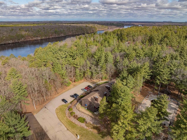 drone / aerial view featuring a view of trees and a water view