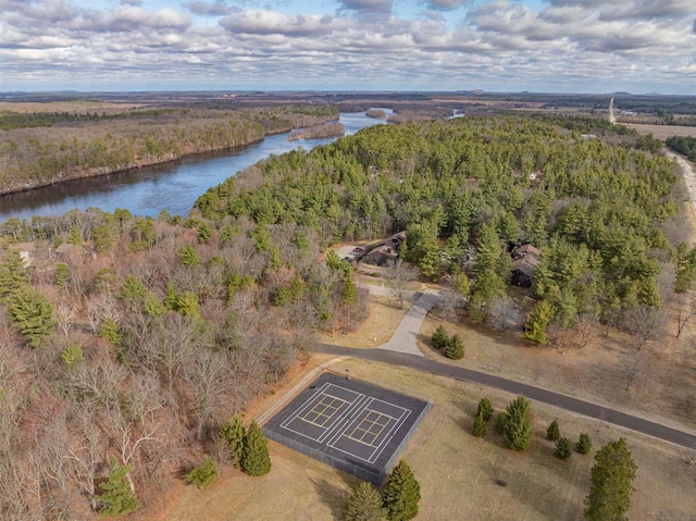 drone / aerial view featuring a water view and a wooded view