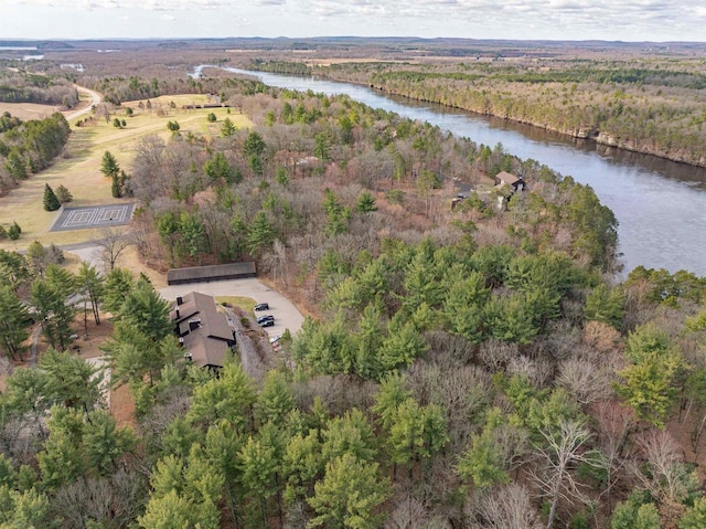 birds eye view of property featuring a forest view and a water view