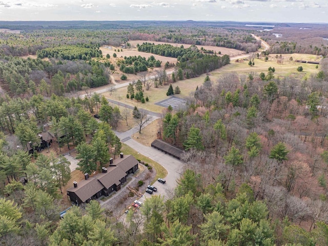 drone / aerial view featuring a wooded view and a rural view