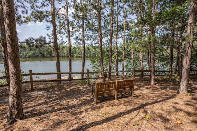 view of yard with a water view and fence