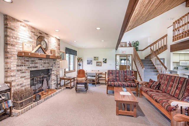 living area featuring recessed lighting, a fireplace, and carpet floors