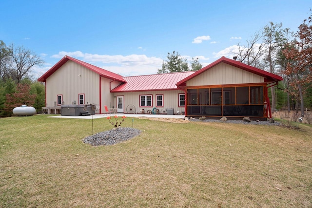 1979 9th Ave, Friendship, WI 53934 - back of property with metal roof, a patio area, a hot tub, a yard, and a sunroom