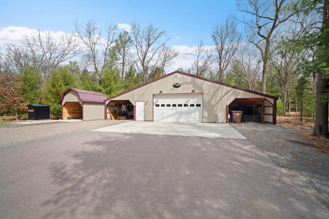 1979 9th Ave, Friendship, WI 53934 - exterior space featuring a detached garage, an outdoor structure, aphalt driveway, and an outbuilding