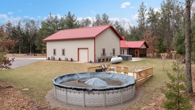 1979 9th Ave, Friendship, WI 53934 - exterior space featuring a covered pool, a hot tub, metal roof, a wooden deck, and a lawn