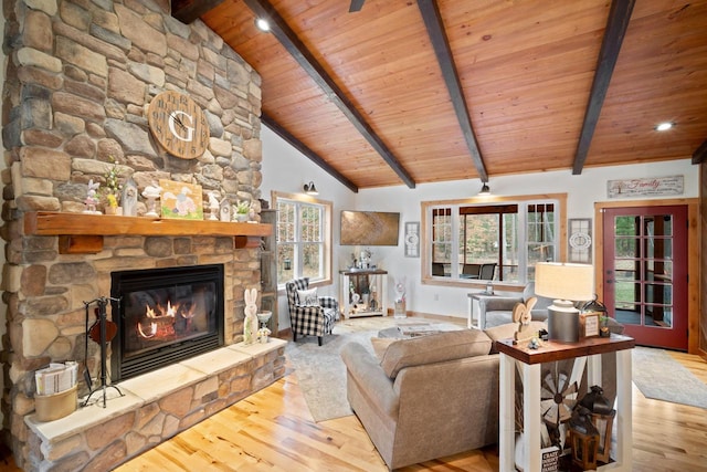 1979 9th Ave, Friendship, WI 53934 - living room featuring wood finished floors, a stone fireplace, vaulted ceiling with beams, and wood ceiling