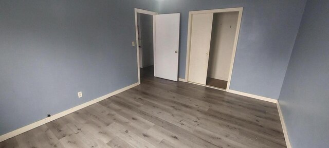 140 E Ave, Iron Ridge, WI 53035 - empty room featuring wood finished floors and baseboards