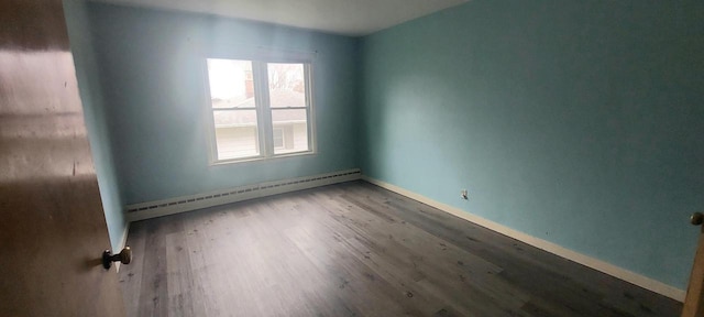 140 E Ave, Iron Ridge, WI 53035 - spare room with baseboard heating, baseboards, and wood finished floors