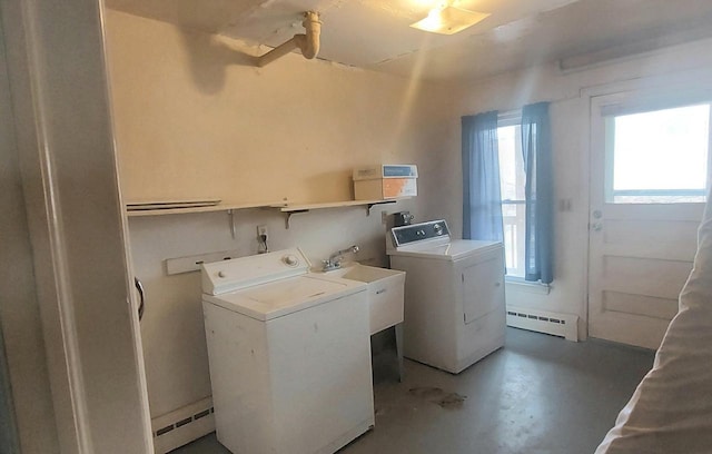140 E Ave, Iron Ridge, WI 53035 - laundry room with washer and clothes dryer, a sink, laundry area, and a baseboard heating unit