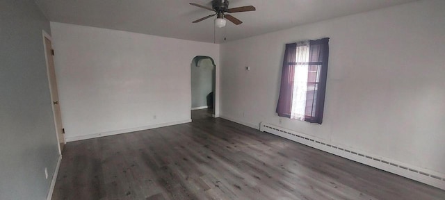 140 E Ave, Iron Ridge, WI 53035 - unfurnished room with baseboards, arched walkways, ceiling fan, baseboard heating, and wood finished floors